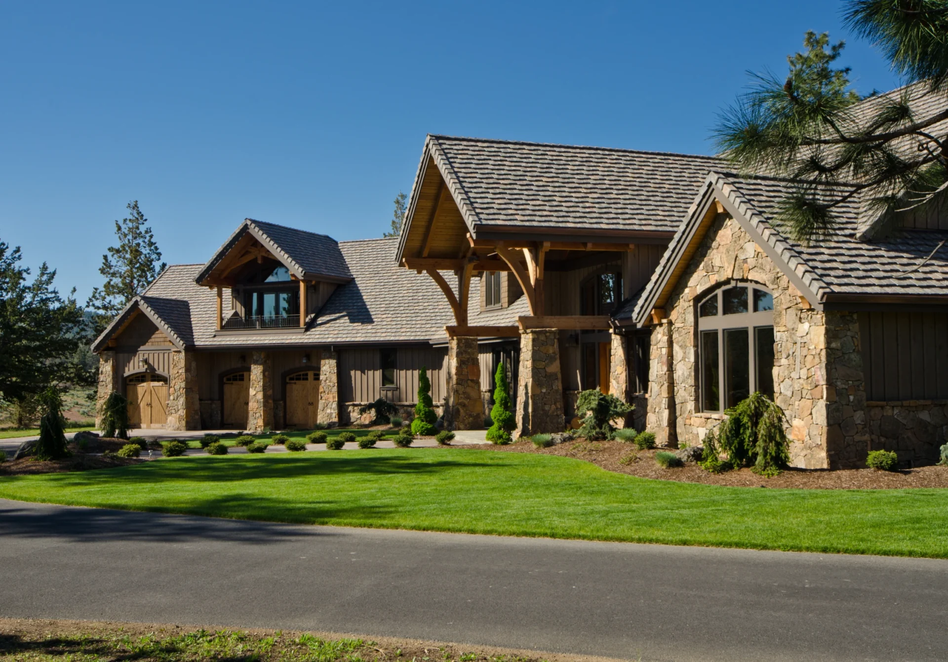 Large stone residence with green lawn