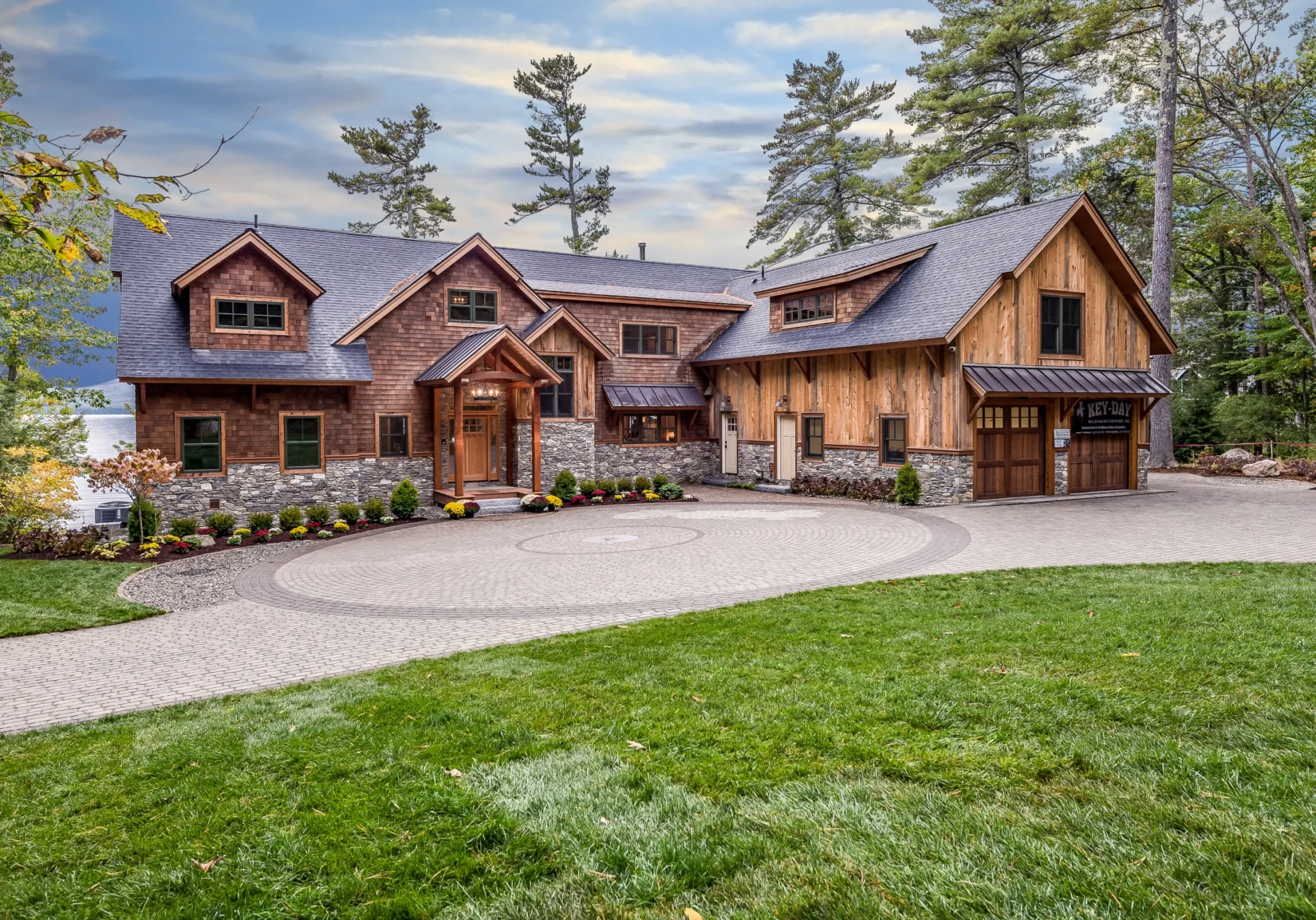 Charming cabin with circular driveway and garden.